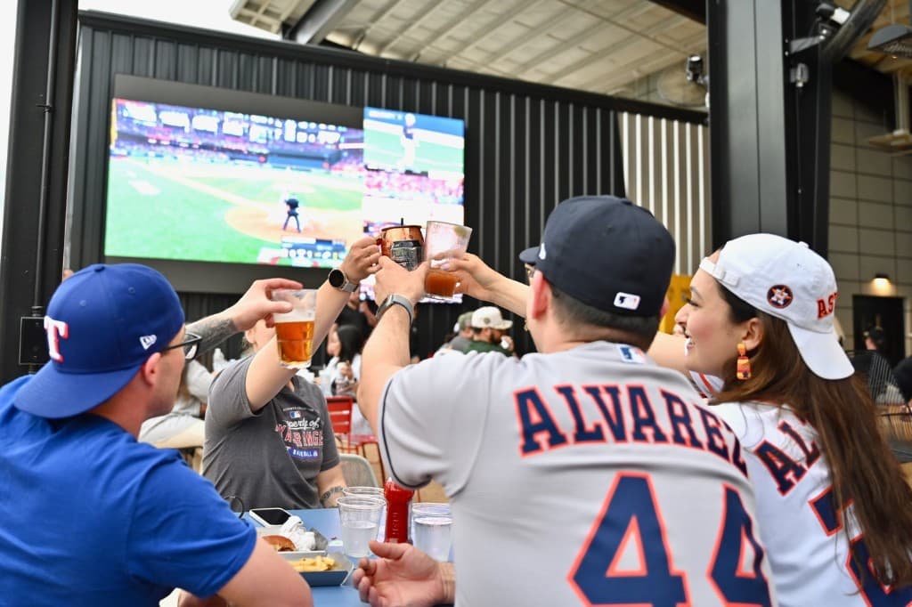 Fans watching the game on the big screen at Home Run Dugout in Katy, TX